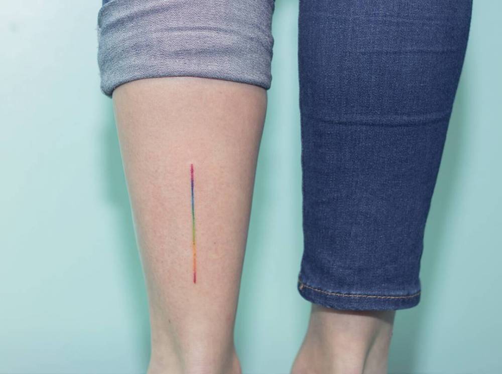 Rainbow line tattoo on the calf