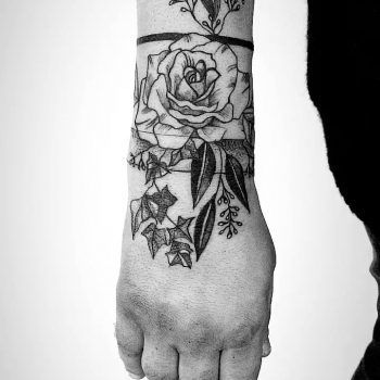 Rose inked around the right wrist