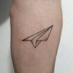 Simple paper plane tattoo