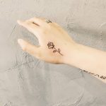 Simple rose tattoo on the hand by tattooist Cholo