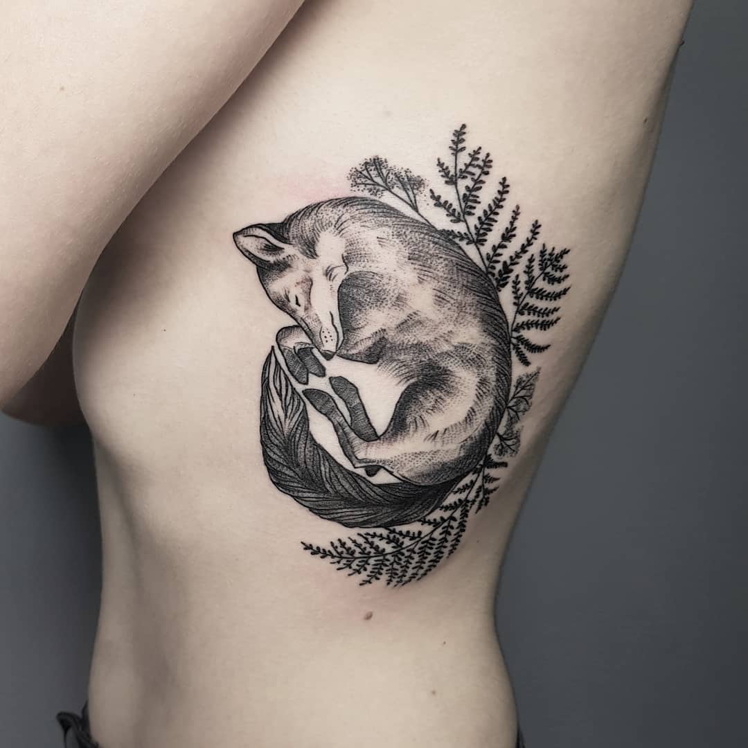 Sleeping fox and fern leaves tattoo