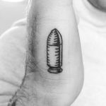 Small bullet tattoo on the hand