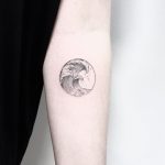 Small circular wave tattoo