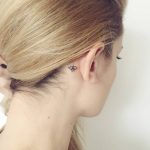 Small eye tattoo behind the right ear