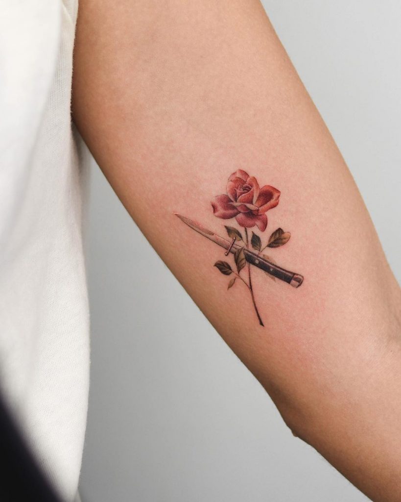 Small flower and switchblade tattoo