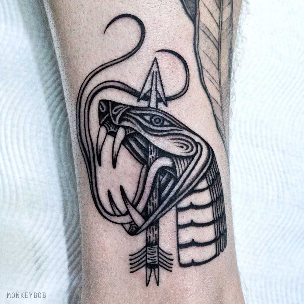 Snake head and arrow tattoo
