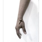 Solid cross tattoo on the hand