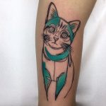 Teal and black cat tattoo