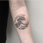 The great wave of Hokusai tattoo on the arm