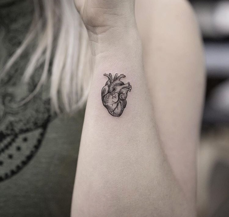 Tiny anatomical heart tattoo on the wrist