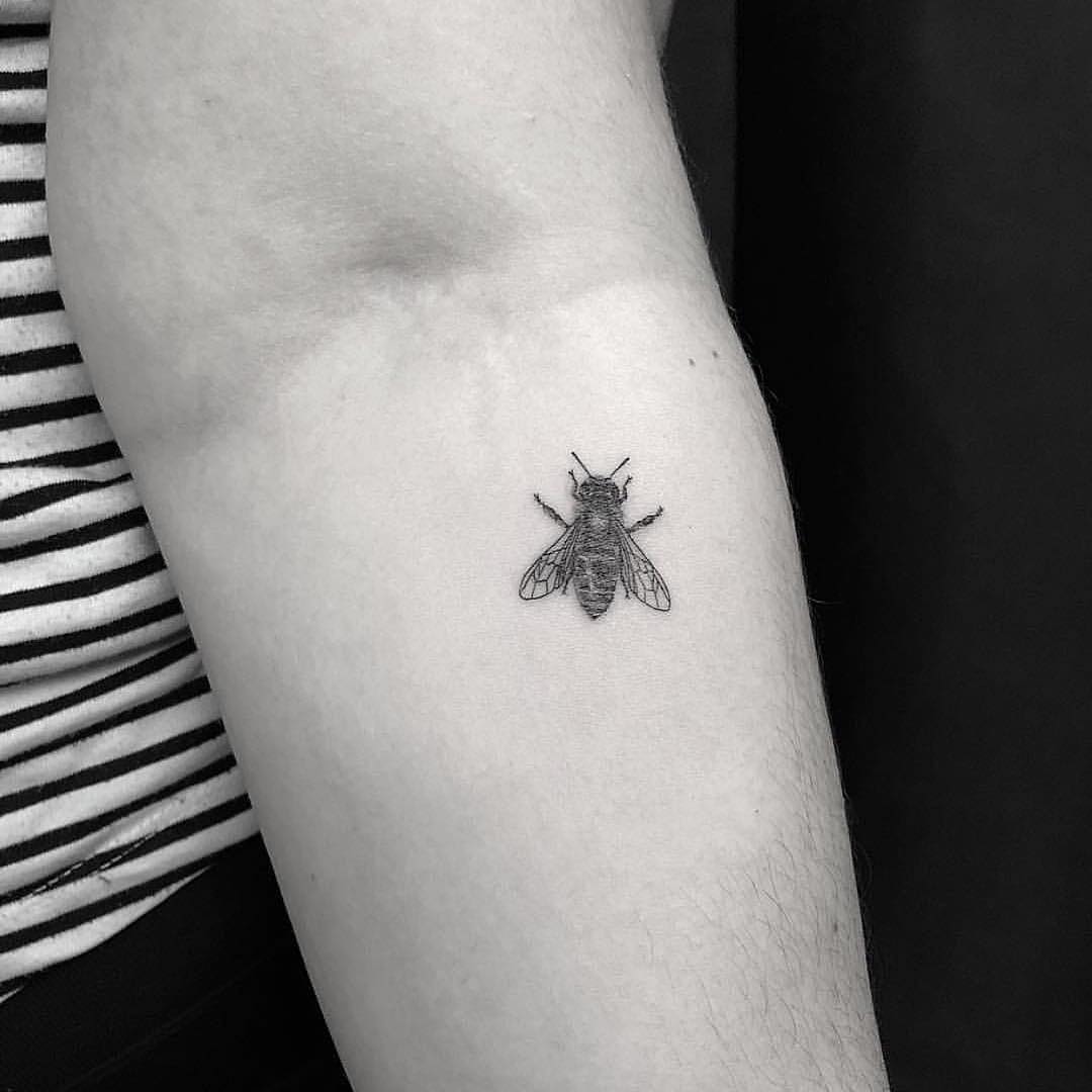 Tiny bee tattoo on the forearm