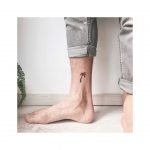 Tiny palm tree inked on the ankle