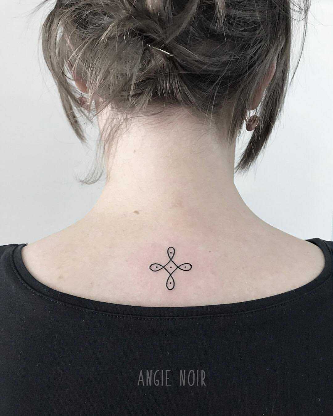 Tiny tattoo on the back by Angie Noir