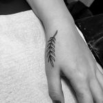 Tiny twig tattoo on the hand