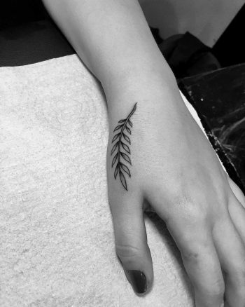 Tiny twig tattoo on the hand