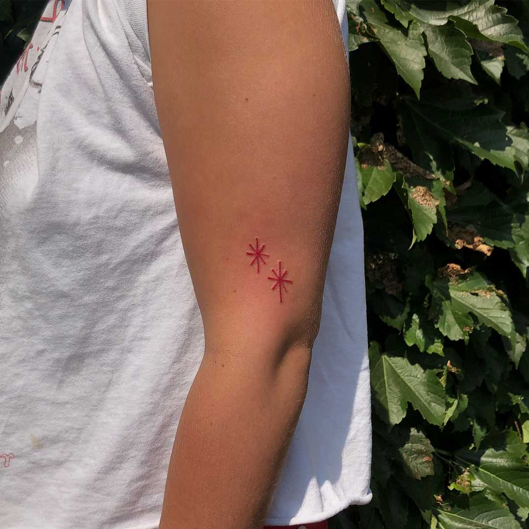 Two red stars tattoo