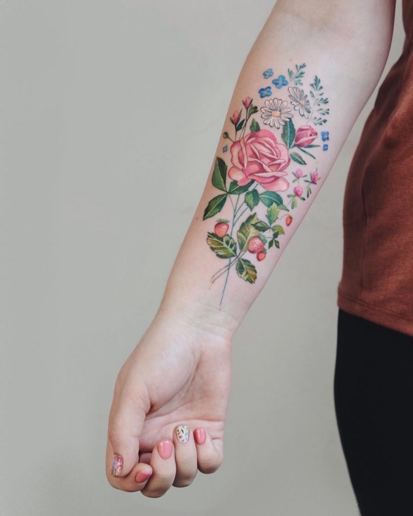 Various colorful flowers tattooed on the forearm