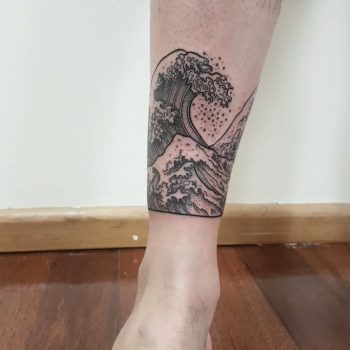 Wave tattoo around the right shin