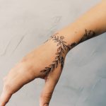 Wrap-around wrist tattoo by Cholo