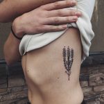 Beautiful plant tattoo on the rib