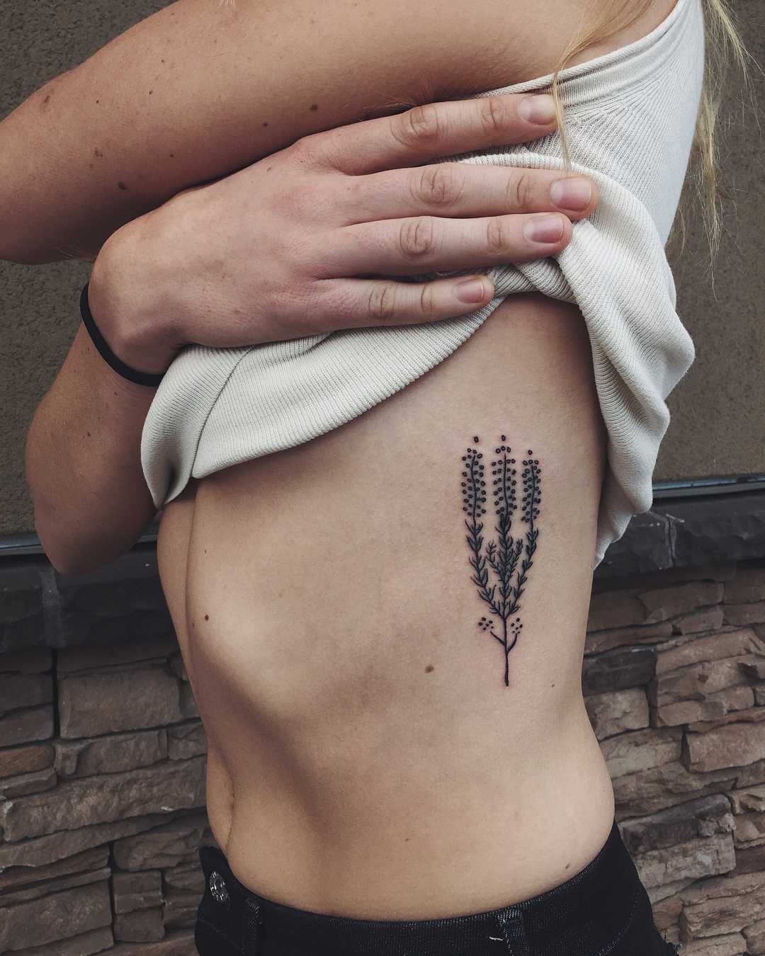 Beautiful plant tattoo on the rib