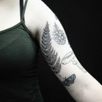 Botanical tattoos on the left arm