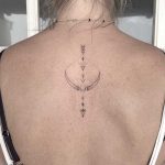 Bow and arrow tattoo on the back