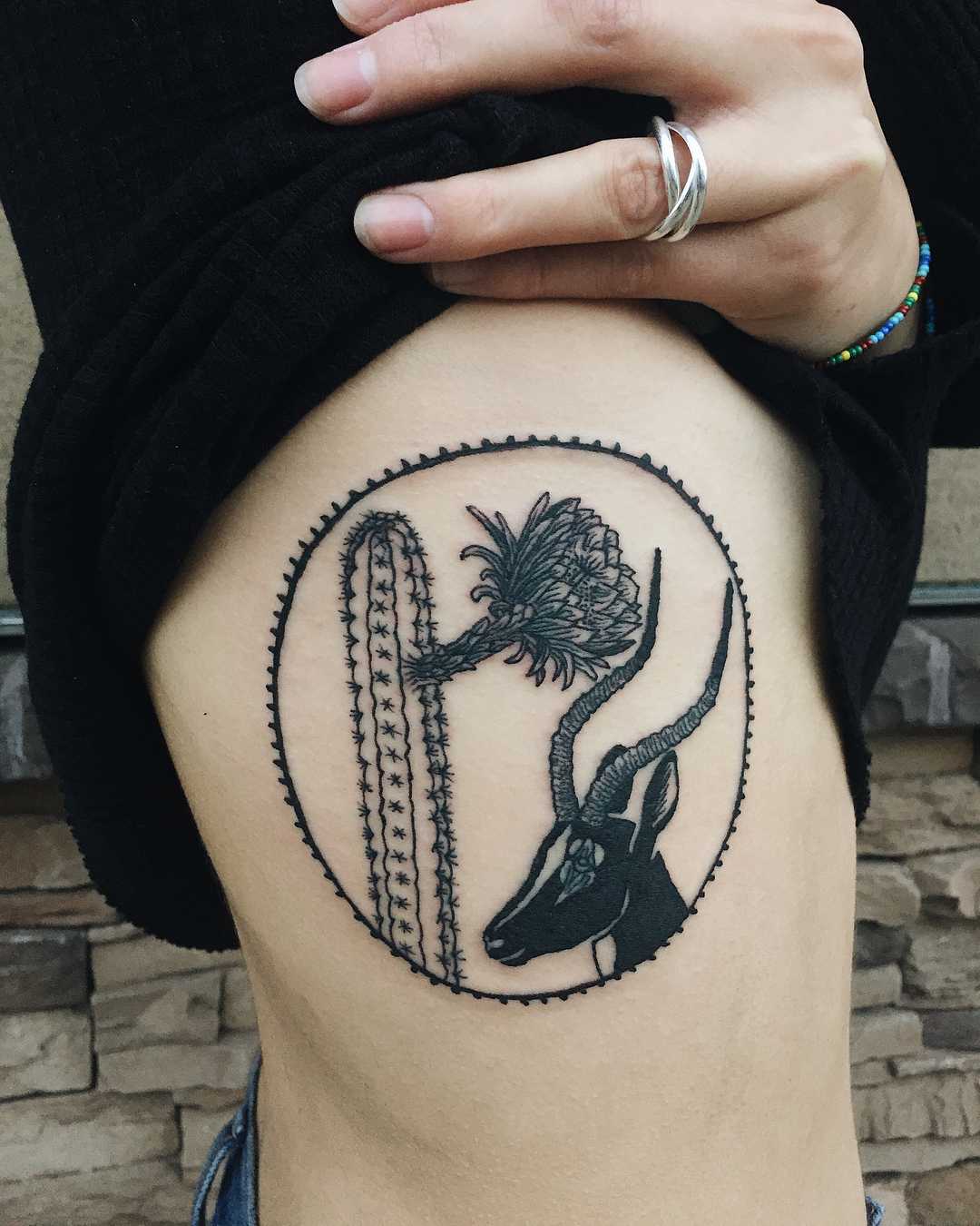 Cactus and antelope tattoo