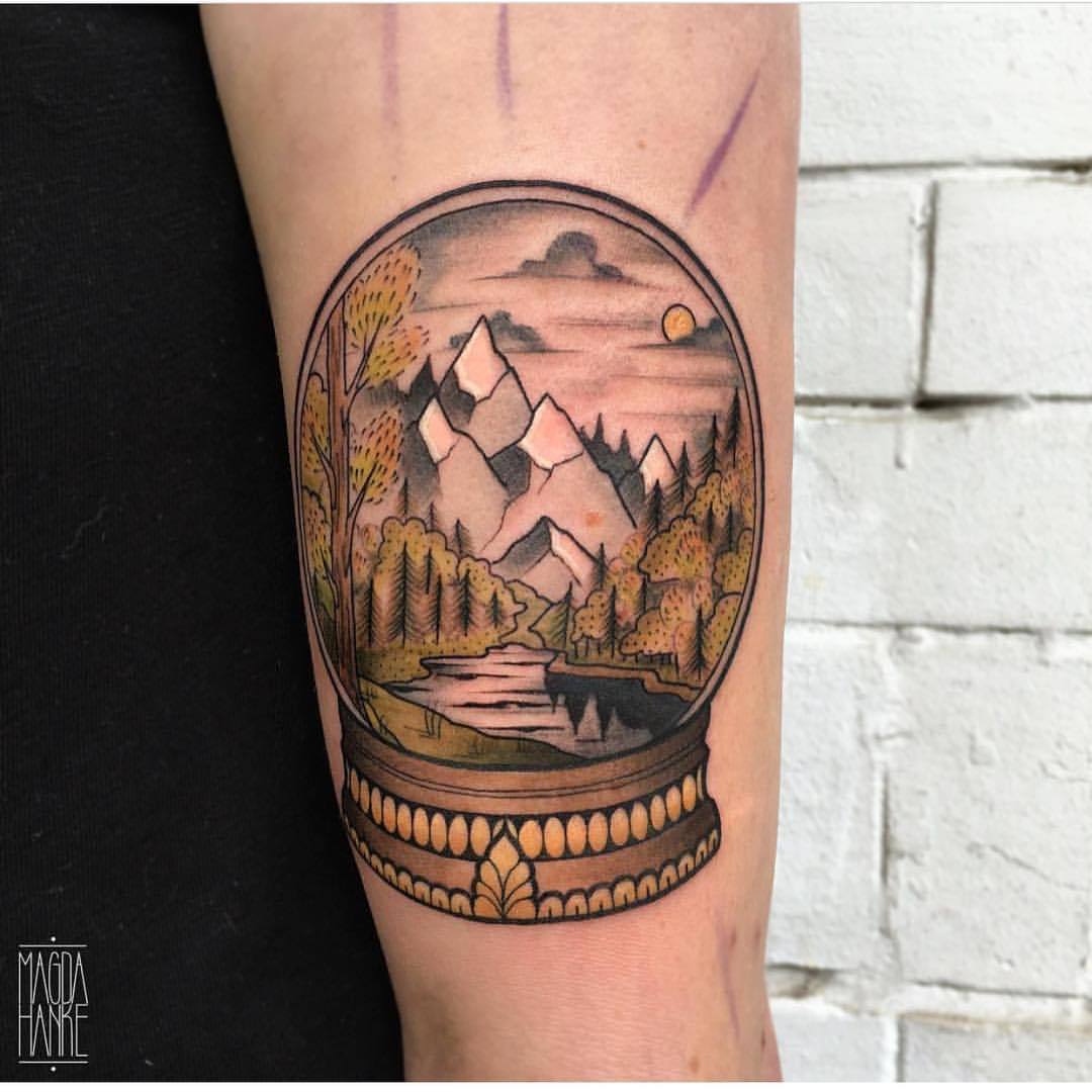 Crystal ball landscape tattoo by Magda Hanke