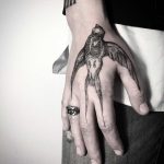 Dead bird tattoo on the hand
