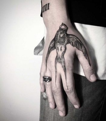 Dead bird tattoo on the hand
