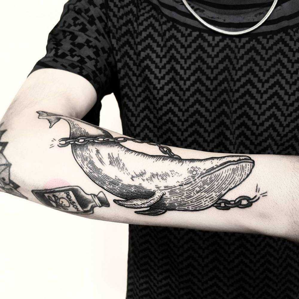 Engraving style tattoo of a whale