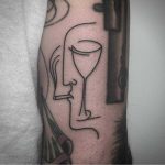 Face wine glass tattoo by Caleb Kilby