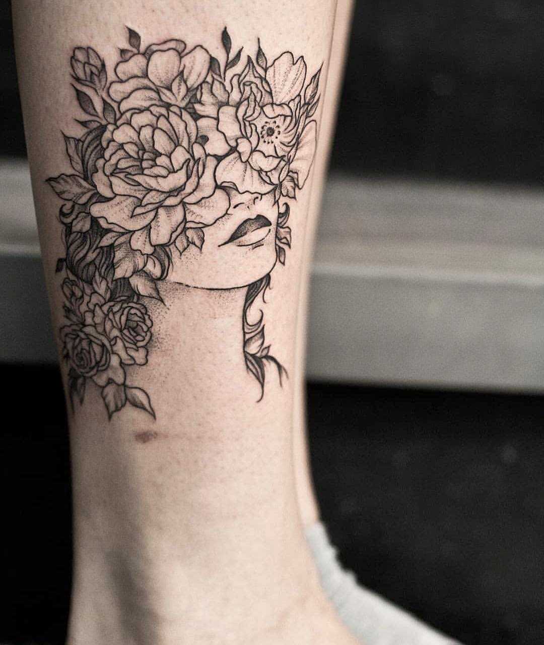 Floral head tattoo on the shin