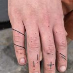 Hand-poked ornaments on the fingers