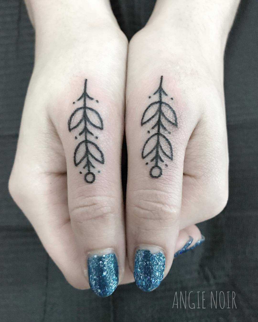Matching thumb tattoos by Angie Noir