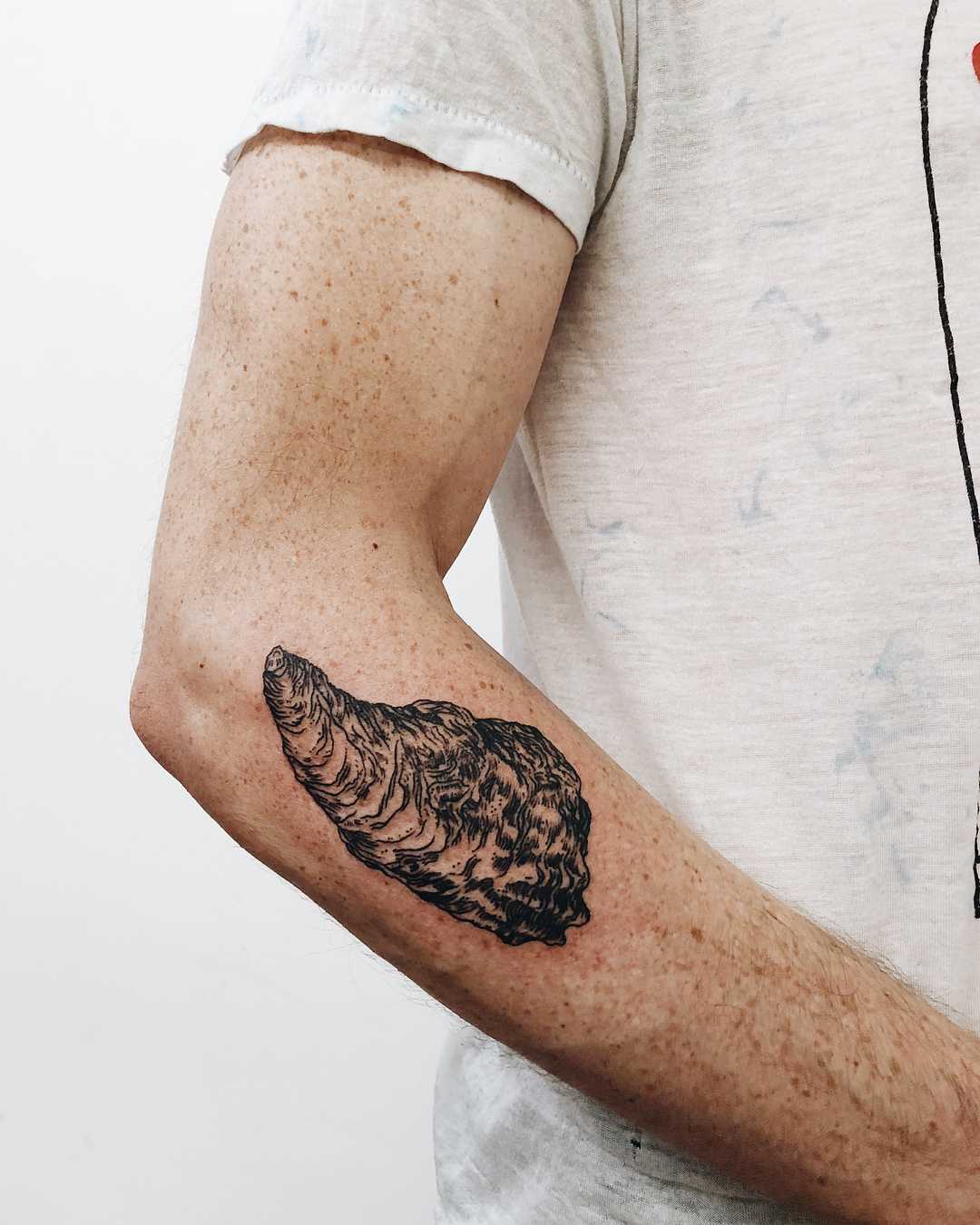Oyster tattoo on the forearm