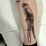 Parrot on a knife tattoo by Nick Whybrow