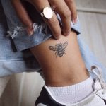 Small bee tattoo on the left ankle