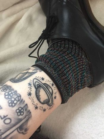 Stick and poke Saturn tattoo