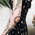 Sun tattoo over the left elbow