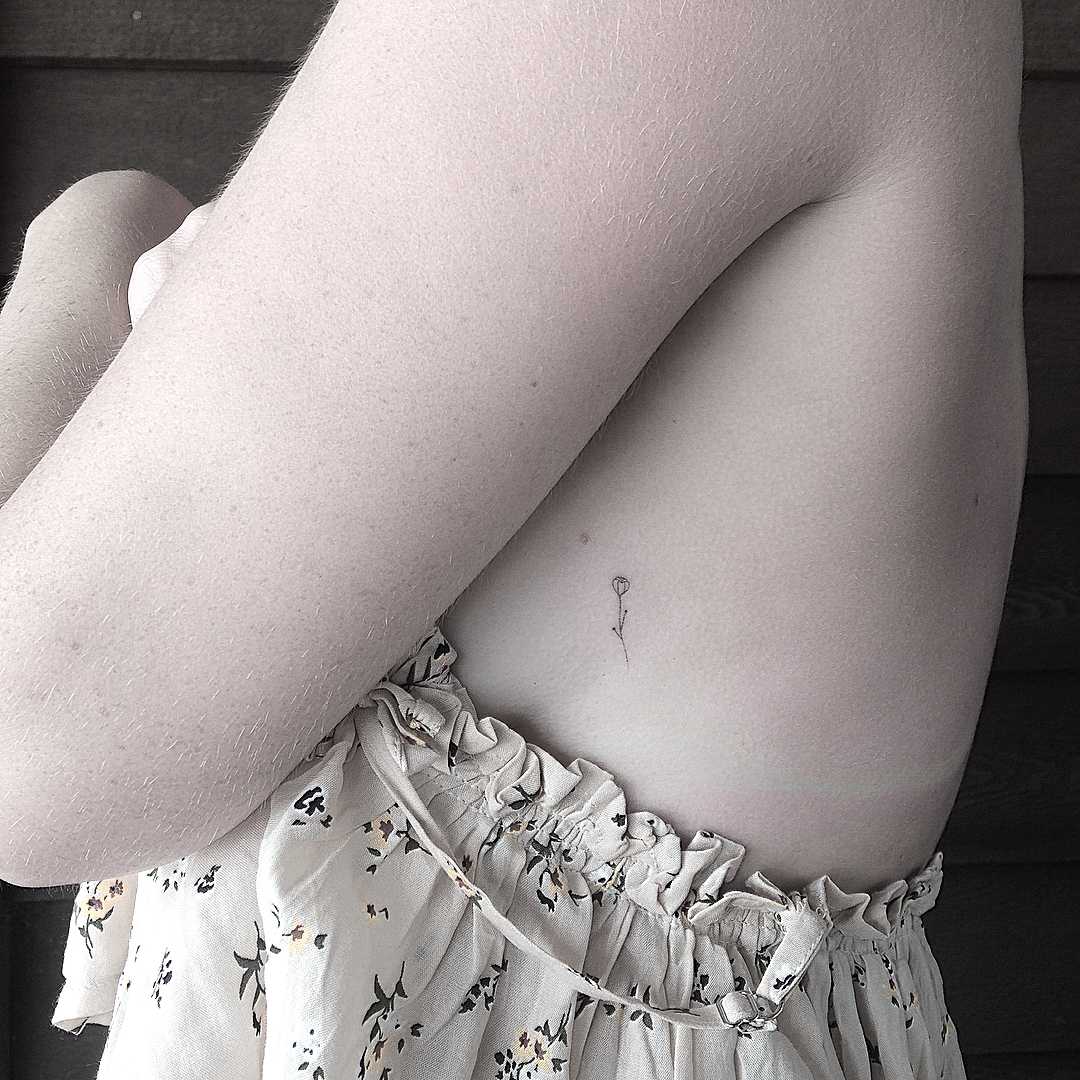Super tiny hand-poked rose tattoo