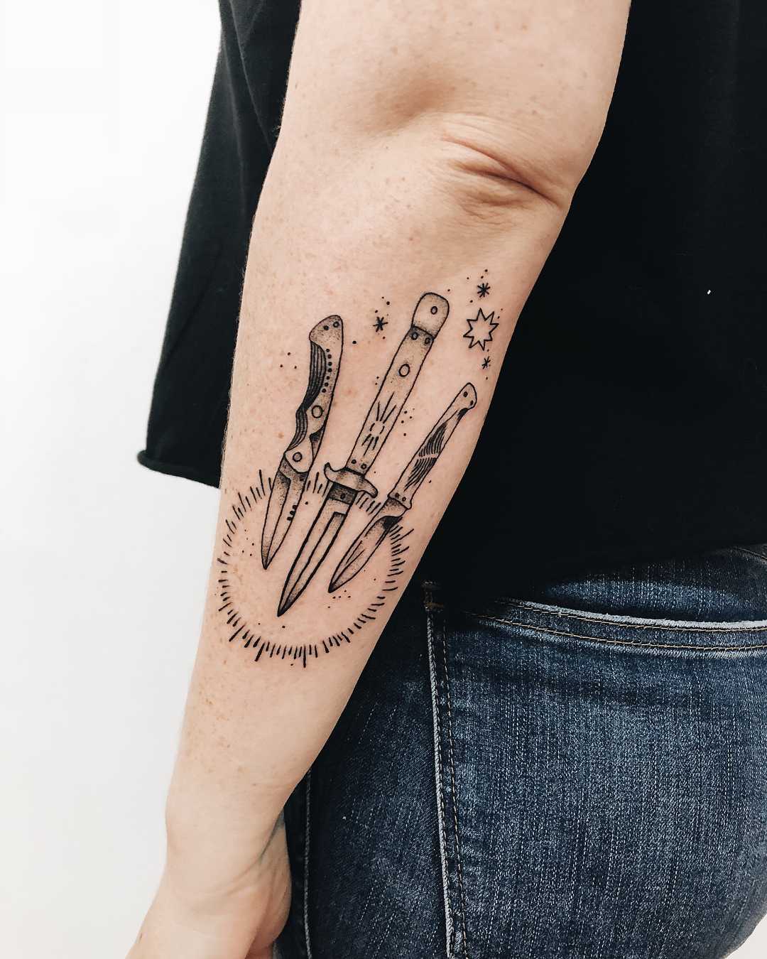 Three knives and sun tattoo