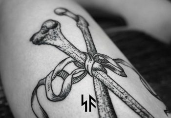 Tied bones tattoo