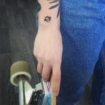 Tiny Saturn tattoo on the wrist