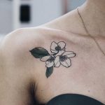 Tiny jasmine tattoo on the collarbone