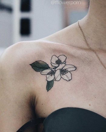 Tiny jasmine tattoo on the collarbone