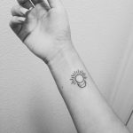 Tiny moon and sun tattoo on the right wrist