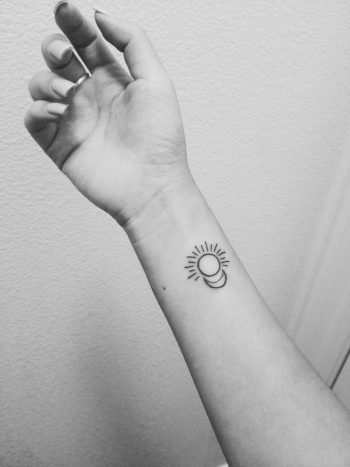 Tiny moon and sun tattoo on the right wrist