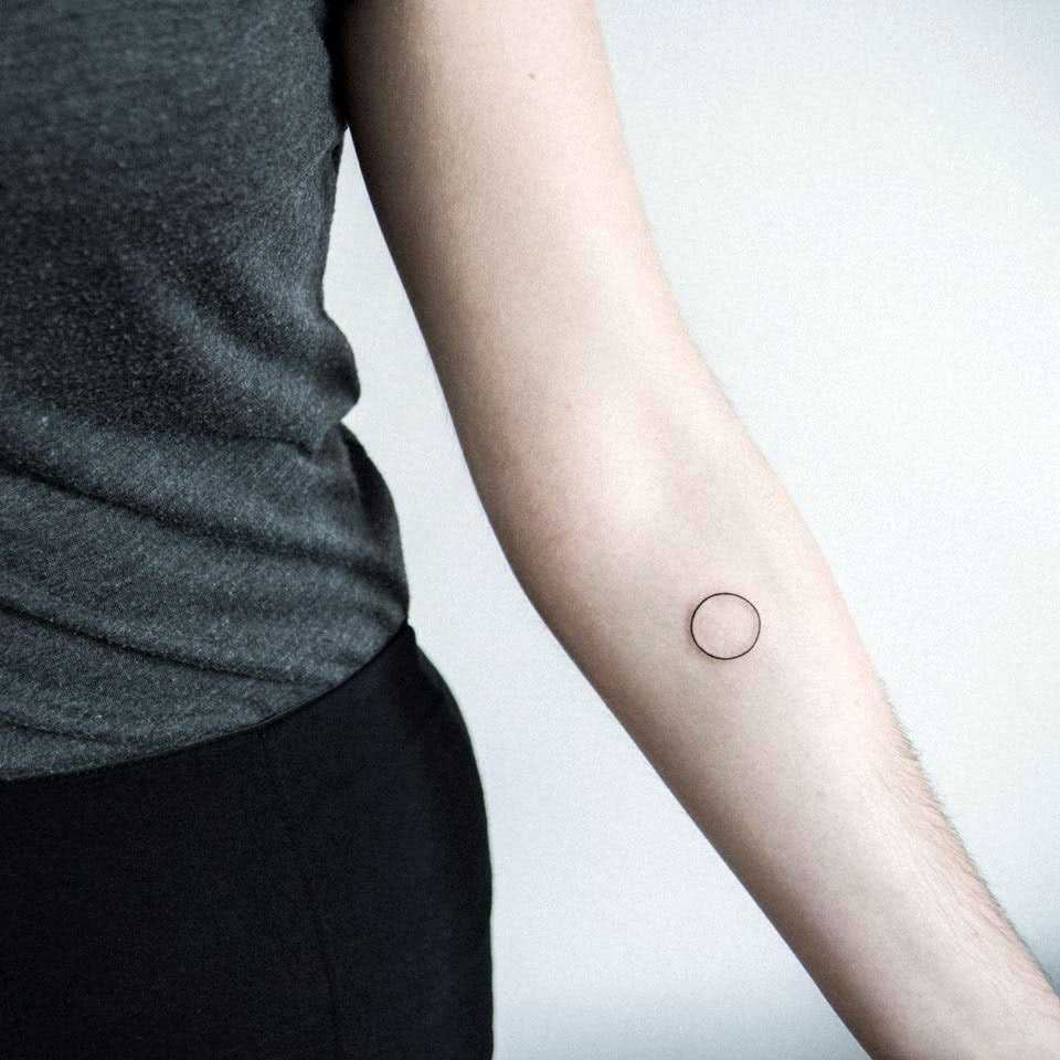 Ultra minimal circle tattoo by Dogma Noir